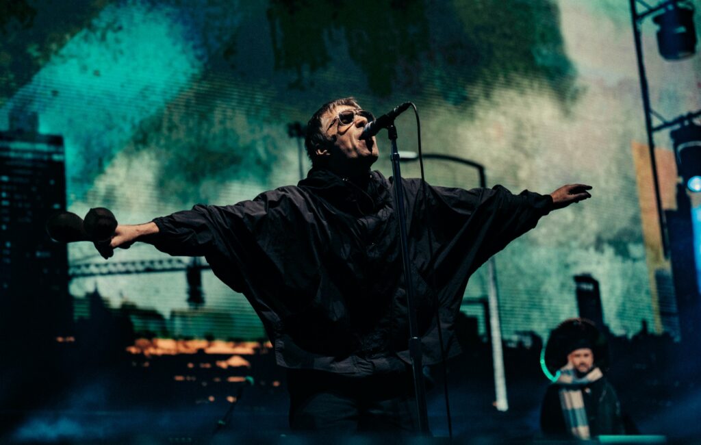 Liam Gallagher performing live on stage with Oasis, photo by Big Brother Recordings