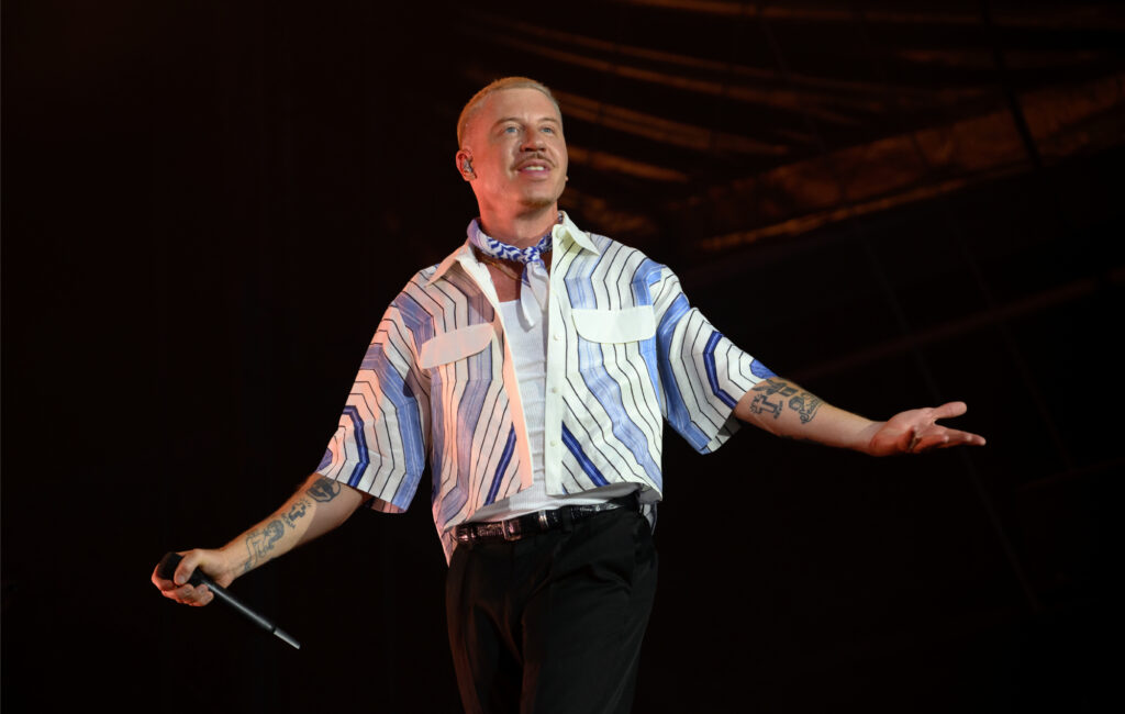 Macklemore performing live on stage, photo by Kristy Sparow/Getty